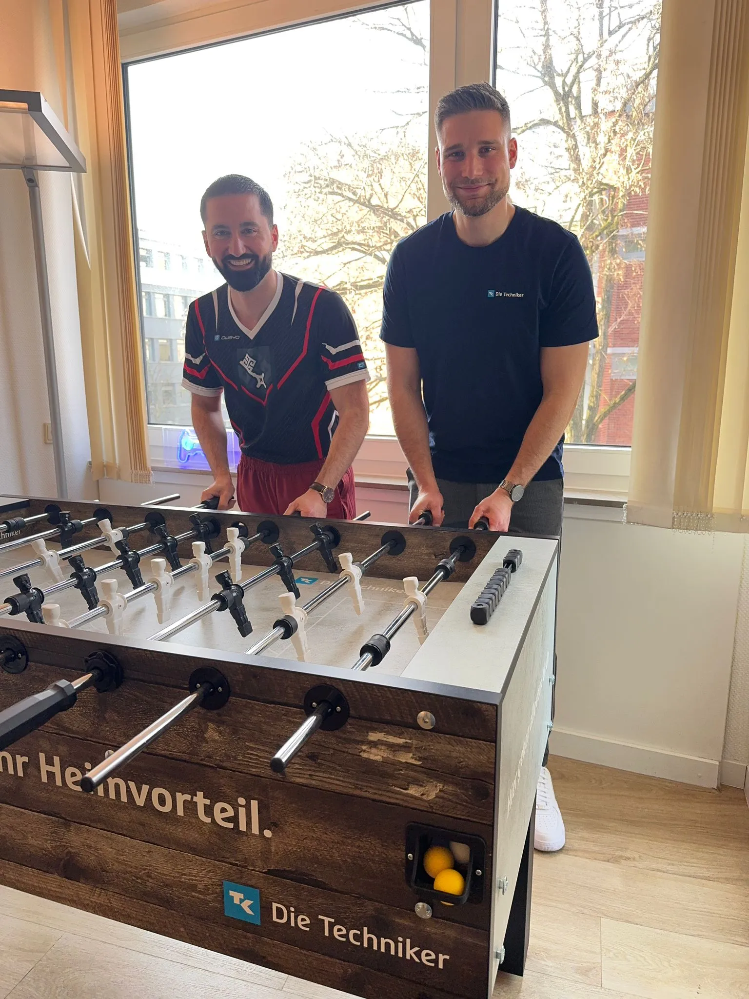 Zwei Personen am neuen Die Techniker Tischkicker im Vereinsheim